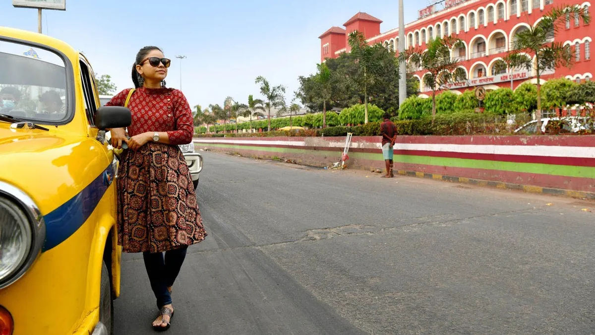Sumona boarding the iconic yellow cab outside the Howrah Station in Kolkata.